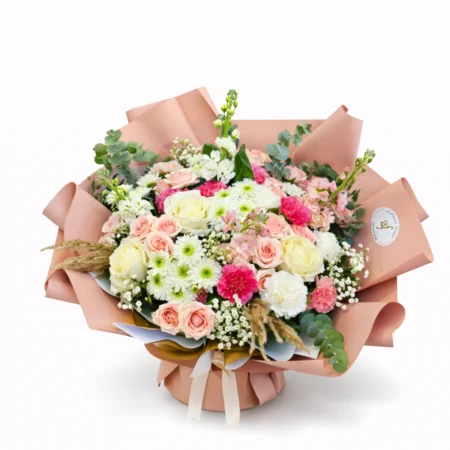 Pastel rose bouquet with white flowers and eucalyptus in peach wrapping